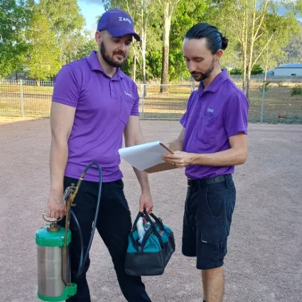 Rob and Dale reviewing an integrated pest management plan, for a customer prior to starting work.